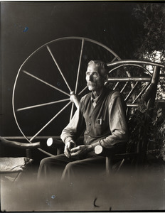 Dugout Dan (Dana Smith): portrait inside his dugout, with spinning wheel
