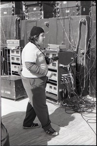 Hollywood Speedway Rock Festival: man with camera walking past sound equipment