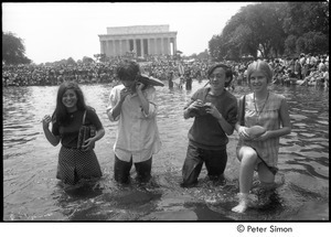 Stephen Davis and Raymond Mungo with two unidentified women, wading in a Mall reflecting pool during the Poor People's Campaign Solidarity Day