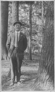 William J. Fahey, Jr. standing outdoors, in forest