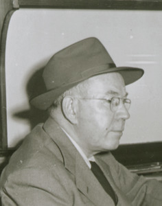 William Leonard Doran sitting indoors