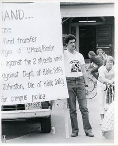 Board of Trustees fee increase demonstration: protestor holding sign