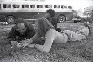 May Day concert and demonstrations: Stuart Werbin (r) lying in the grass, talking to another man