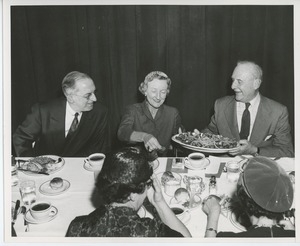 Mrs. Jeremiah Milbank and two unidentfied men at Thanksgiving dinner