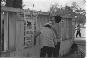 Political workers hanging posters; Phong Dinh.