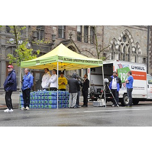 Active Lifestyle Chocolate offers water to "One Run" runners on Boylston St.