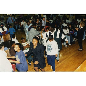 Students dancing in the aisles of their school auditorium during an Areyto program.