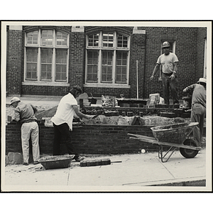 Four workers laying bricks during the Boys' Clubs of Boston Charlestown Clubhouse renovation