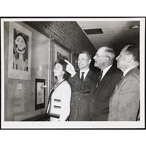 From left to right, Mrs. Frederic Church, Richard Harte, Jr., Richard H. Bassett, and Paul F. Hellmuth viewing the Boys' Clubs of Boston Fine Arts Exhibit at the Amory Coolidge Gallery, Museum of Science