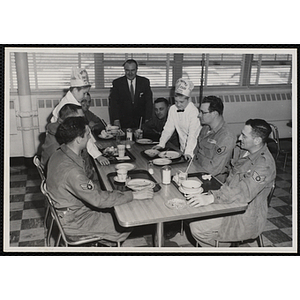 Members of the Tom Pappas Chefs' Club clear a table in the Hanscom Air Force Base restaurant