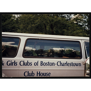 Boys gesticulate from the window of the Boys and Girls' Clubs of Boston-Charlestown Club House van