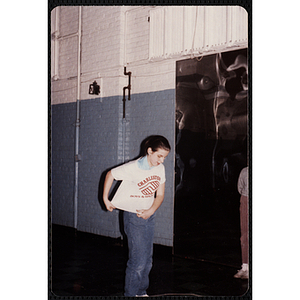 A girl takes off a Charlestown t-shirt at the Charlestown gymnasium