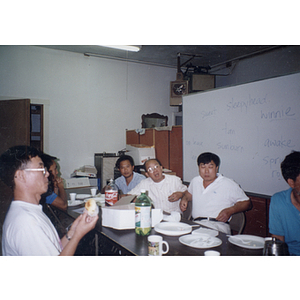 Chinese Progressive Association adult education class eats together at a table