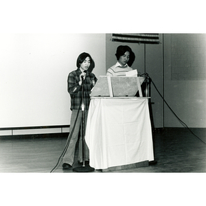 Two Chinese men speak at the podium at an event about the normalization of U.S. and China relations