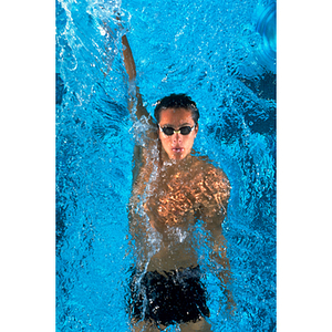 Male swimmer practicing his backstroke