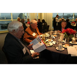 George Makris looks at a brochure during the Veterans Memorial dinner