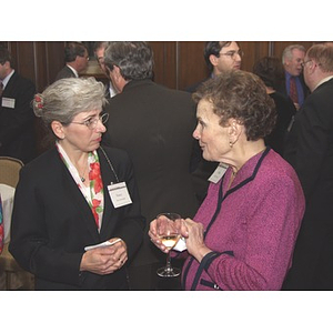 Two women talking at gala dinner for John Hatsopoulos