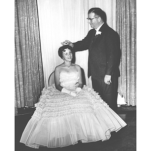 President Knowles places a crown atop Homecoming Queen Elizabeth Anderson's head