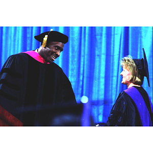 Dean David Hall presenting law school graduate with degree