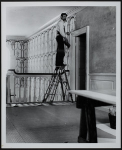 Worker on ladder installing wallpaper, Hamilton House, South Berwick, Maine, 1898