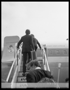 Men ascending the ramp of a Pan American airways Boeing 707