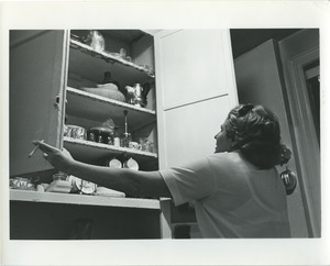 Miriam examines the cupboards