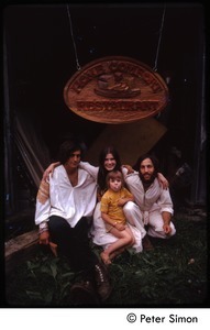 Tim Rossner (?),Catherine Blinder, Elliot Blinder, and child seated under Home Comfort Restaurant sign