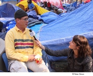 Occupy Wall Street: reporter from the Wall Street Journal interviewing demonstrator