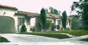 Spanish-colonial style stucco house with foundation plantings