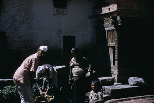 Three men walking down a street in Bhaktapur