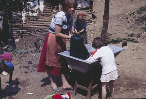 Mother and daughter wash clothes in Volce