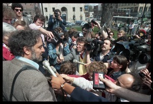 Scene outside the Hampshire County courthouse following acquittal in the CIA protest trial: Abbie Hoffman being interviewed by the press