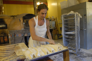 Hungry Ghost Bread: owner and baker Jonathan C. Stevens preparing bread dough for proofing