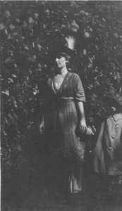 Unidentified woman and child holding hands outside