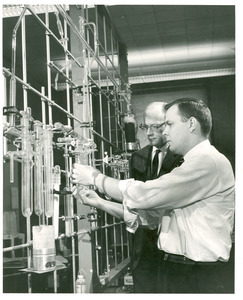 Thomas R. Stengle and unidentified man in a chemistry lab