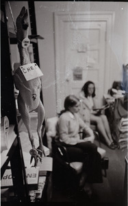 Young Americans for Freedom (YAF) office: rubber chicken hanging from a storage shelf; two women seated in background