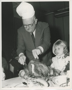 Sam Farnsworth carving turkey for young client