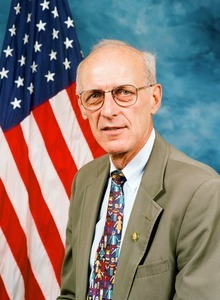 Congressman John W. Olver: studio portrait with U.S. flag