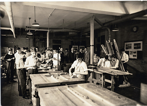 [Students working in the machine shop]
