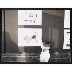 Charlestown Boys' Club member Dennis Callahan points to his entry in the Boys' Clubs of Boston Tri-Club Art Exhibit at the Museum of Science