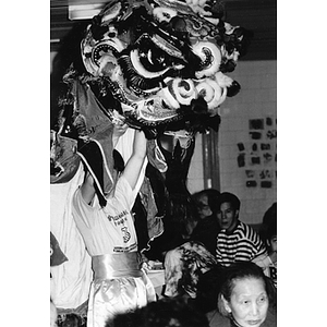 Dancer performs a Dragon Dance at a dinner held at the Josiah Quincy School, marking Chinatown's victory to build a community center on Parcel C