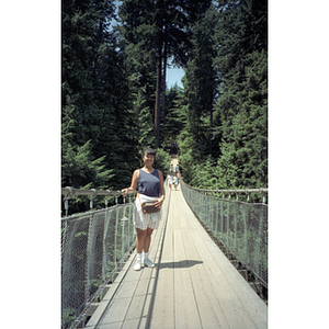 Young woman stands on the Capilano Suspension Bridge