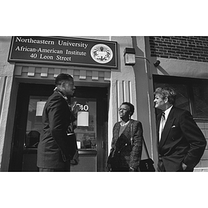 Dean Keith Motley, Mrs. John O'Bryant, and President Curry stand outside the African-American Institute