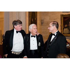 President Aoun greets two men at the inauguration celebration