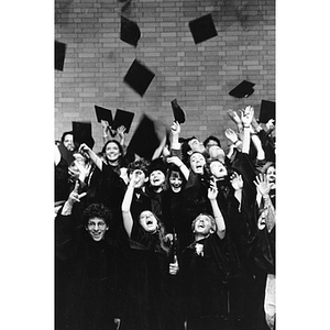 Students throw their caps in the air at the Law School commencement ceremony