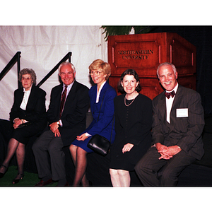 Five people pose together at a 25 Year Associates event