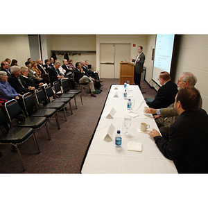 Peter Barrett, PhD '79, speaks while guests and other panelists look on at the NU Today Cancer Research Panel