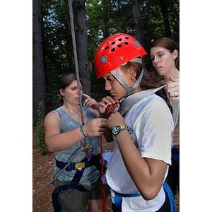 Melanie Arvajo puts on her harness at Torch Scholars Project Adventure Ropes Course