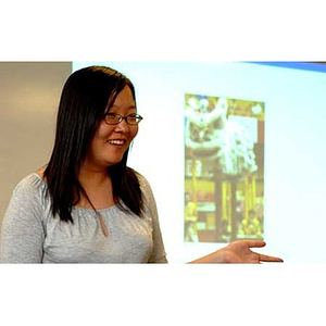 Qinrui Pang gestures in front of an image at the Torch Scholars talent show