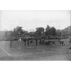 Football players on Huntington Field during a Northeastern / Colby game
